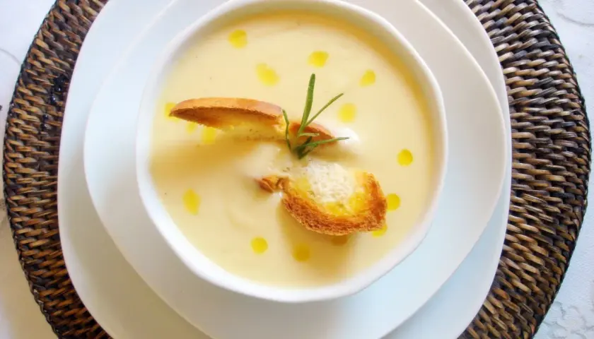 Crema de puerros y patatas con nata, coronada con picatostes crujientes y un toque de romero.